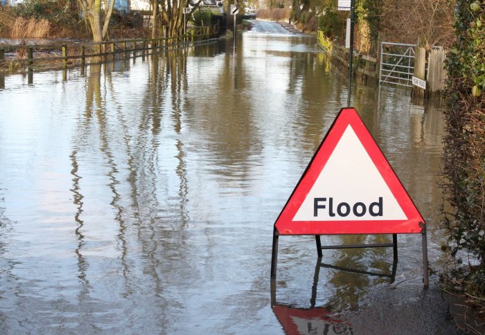 flooded road with warning sign