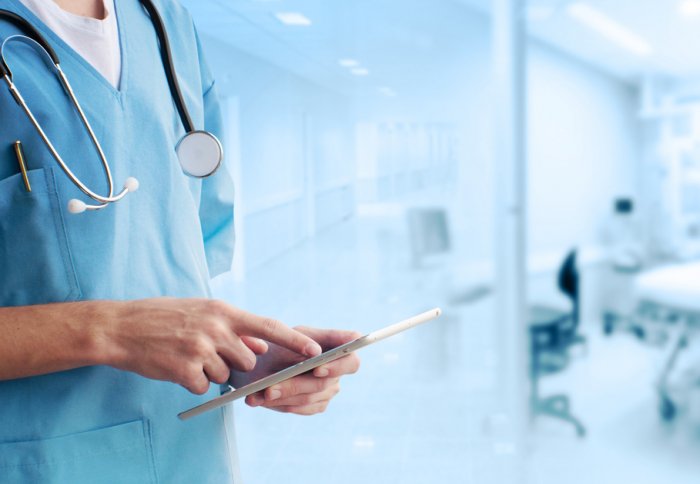 medical staff using a tablet device