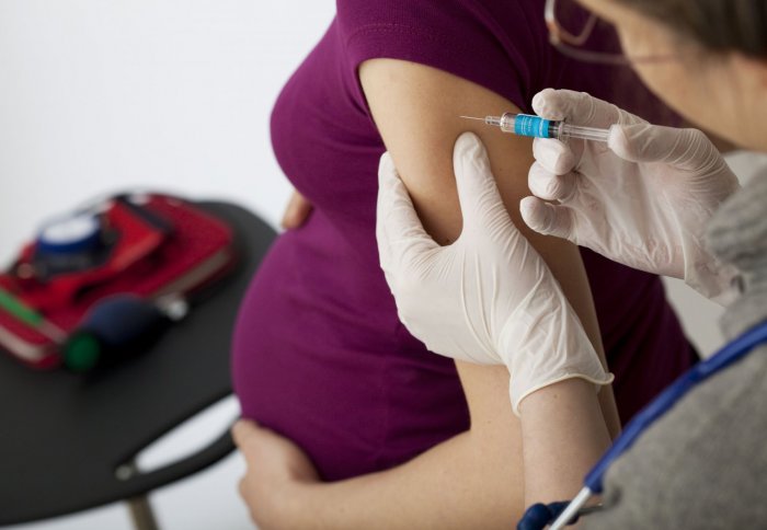 Pregnant woman receiving vaccinaton
