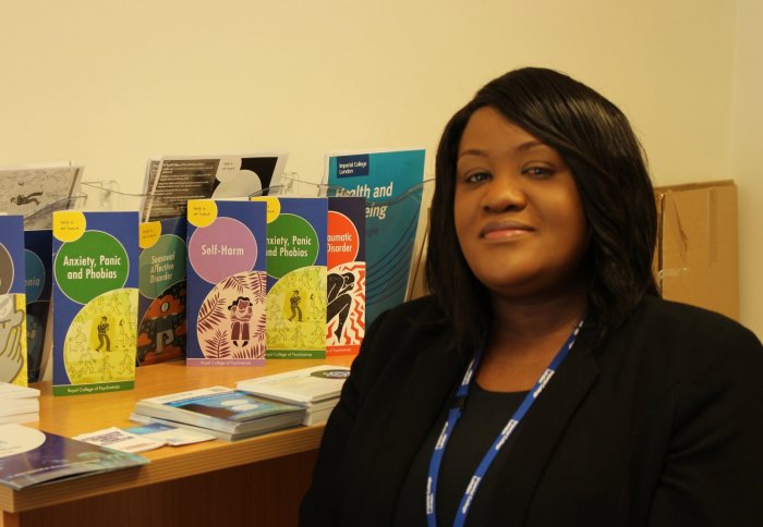 woman sitting in front of self-help leaflets