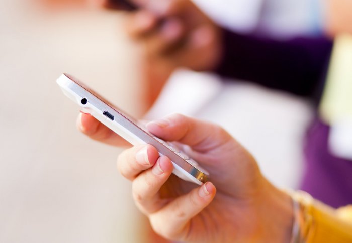 Hand texting on a smartphone