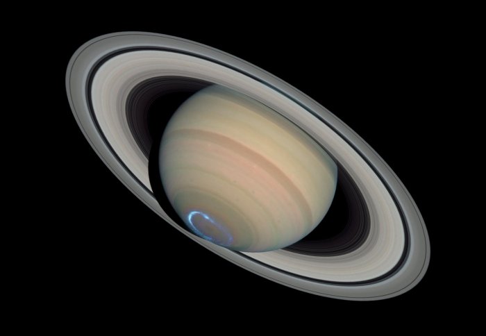 A view of Saturn, with a small ring of blue at the south pole