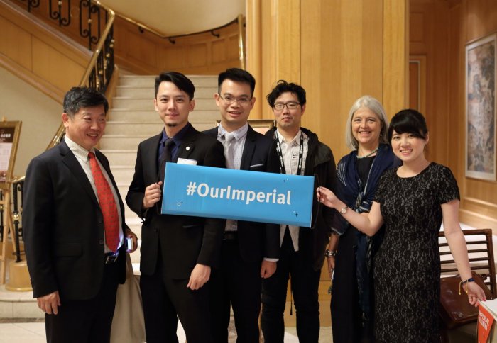 Alumni in Taipei holding an Our Imperial banner