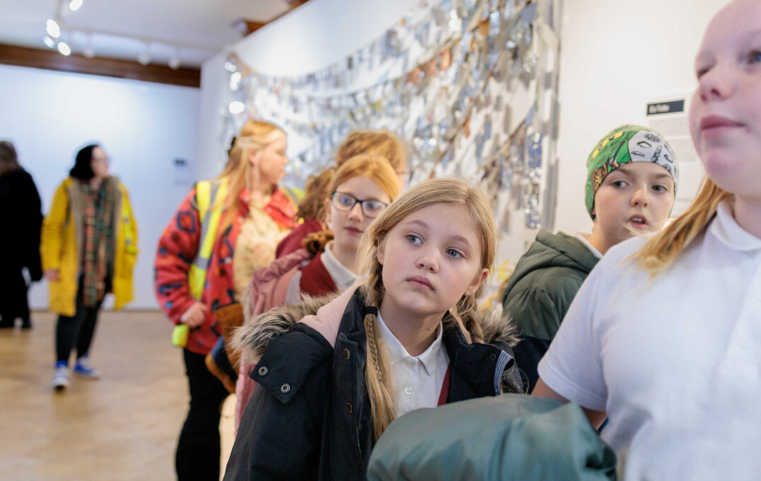 A girl at a gallery looking at art