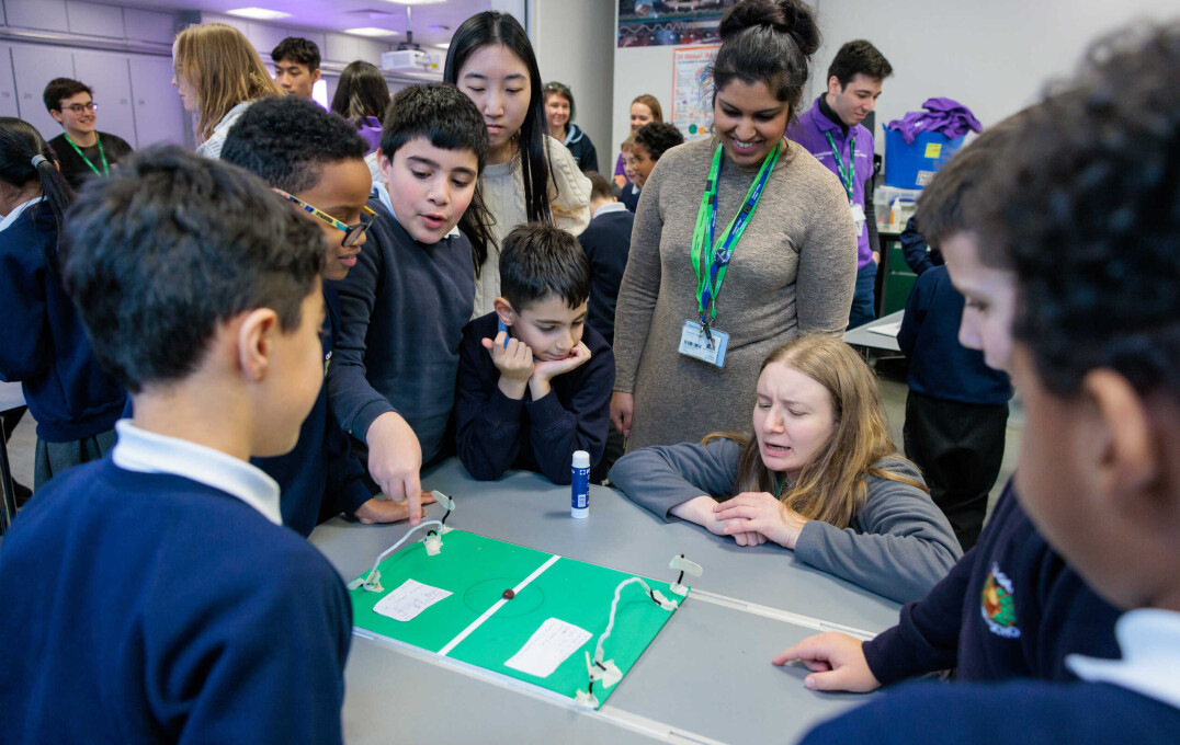 Children around a homemade football pitch