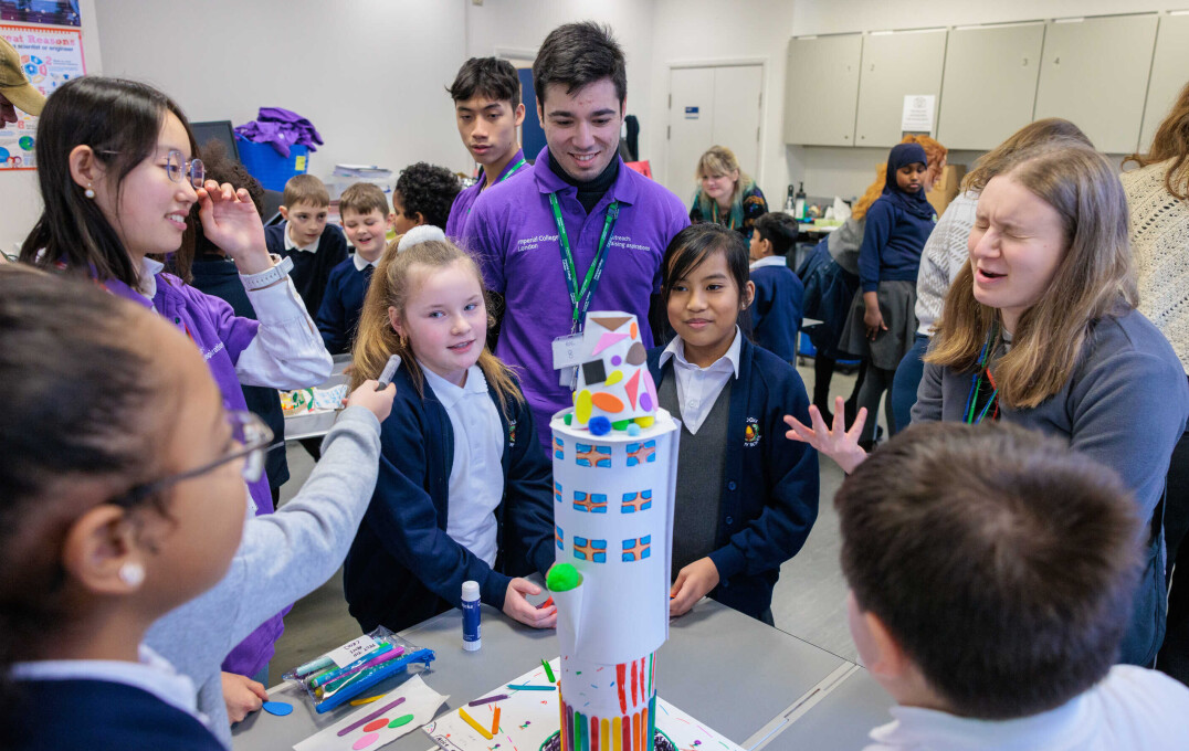 Children stand around a homemade rocket