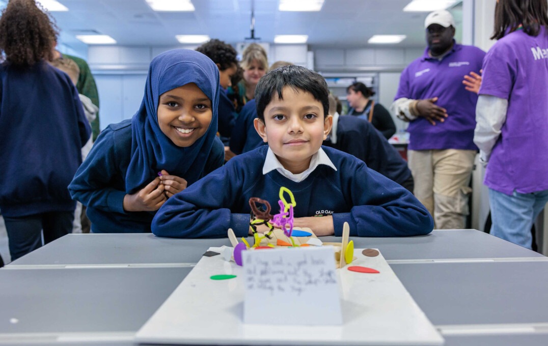 Children stand around their crafts