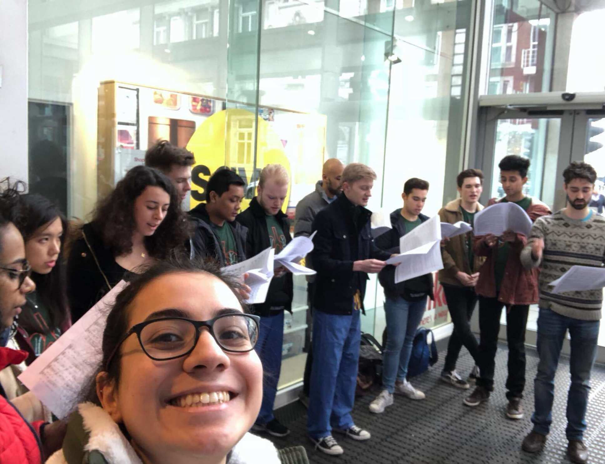 A group of students sings to raise money