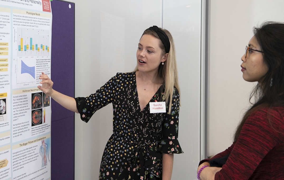 Student presenting a poster