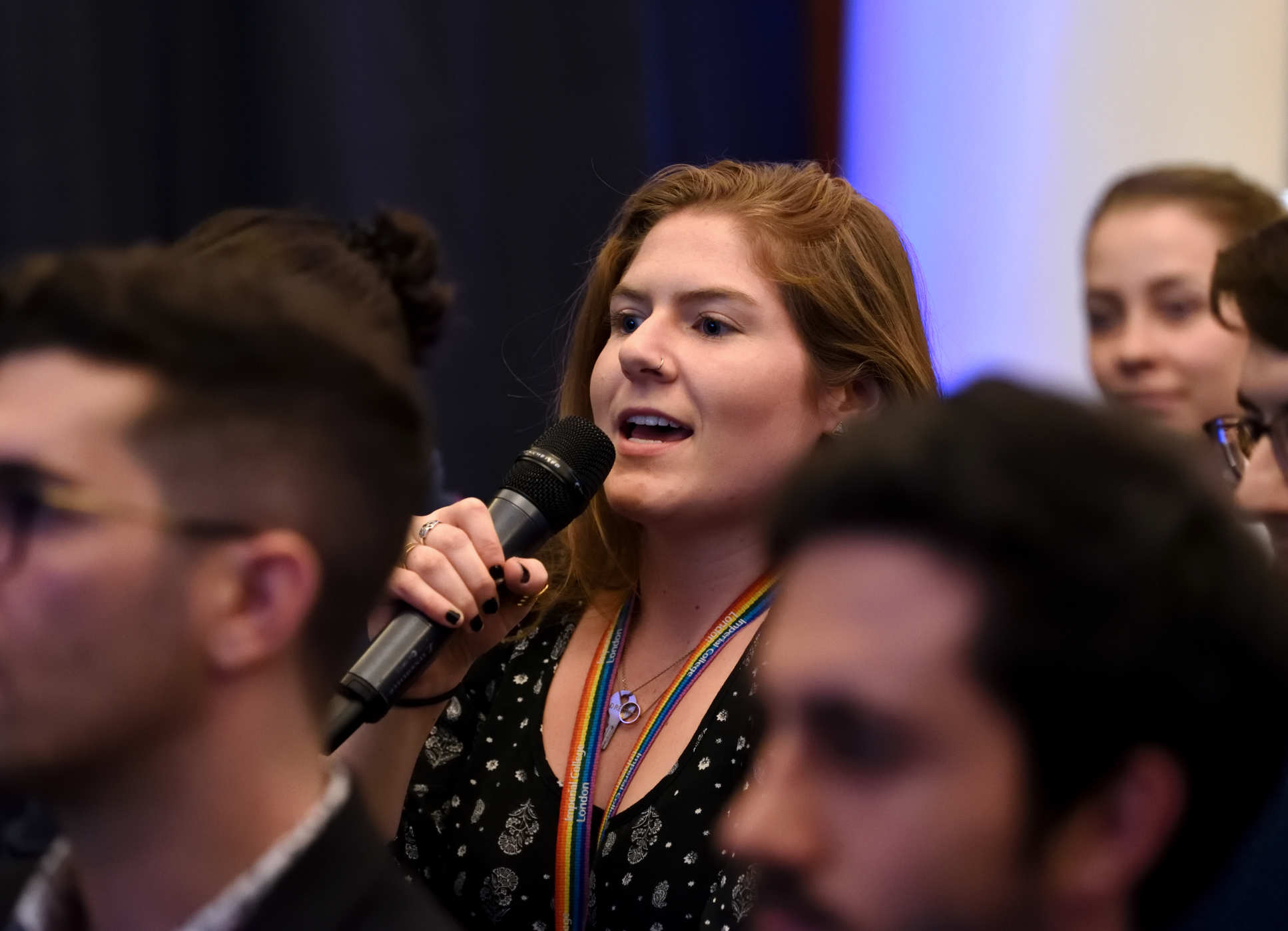 A member of the audience asking a question to the panelists