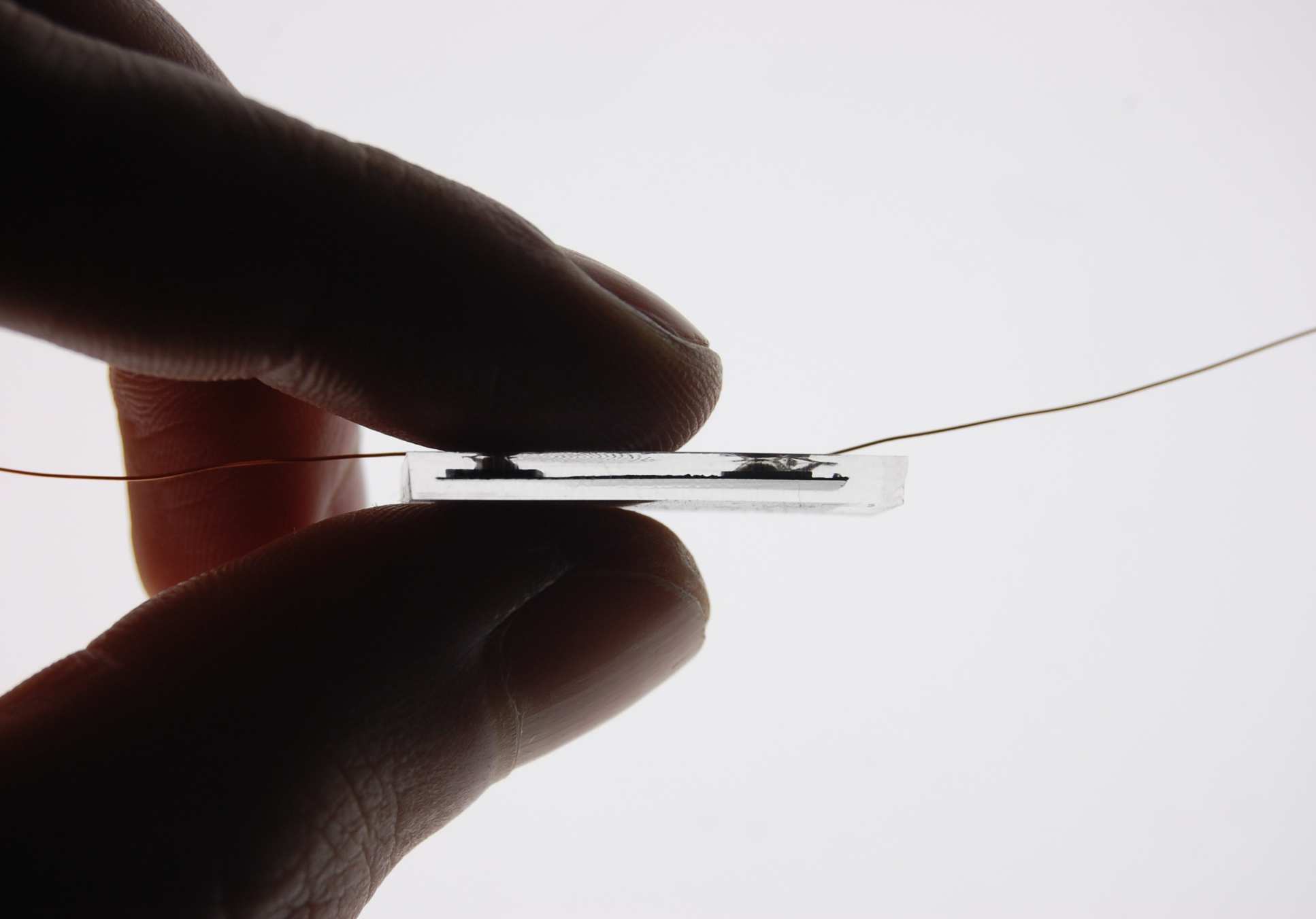 Electronics within a stretchy transparent rubber held between two fingers