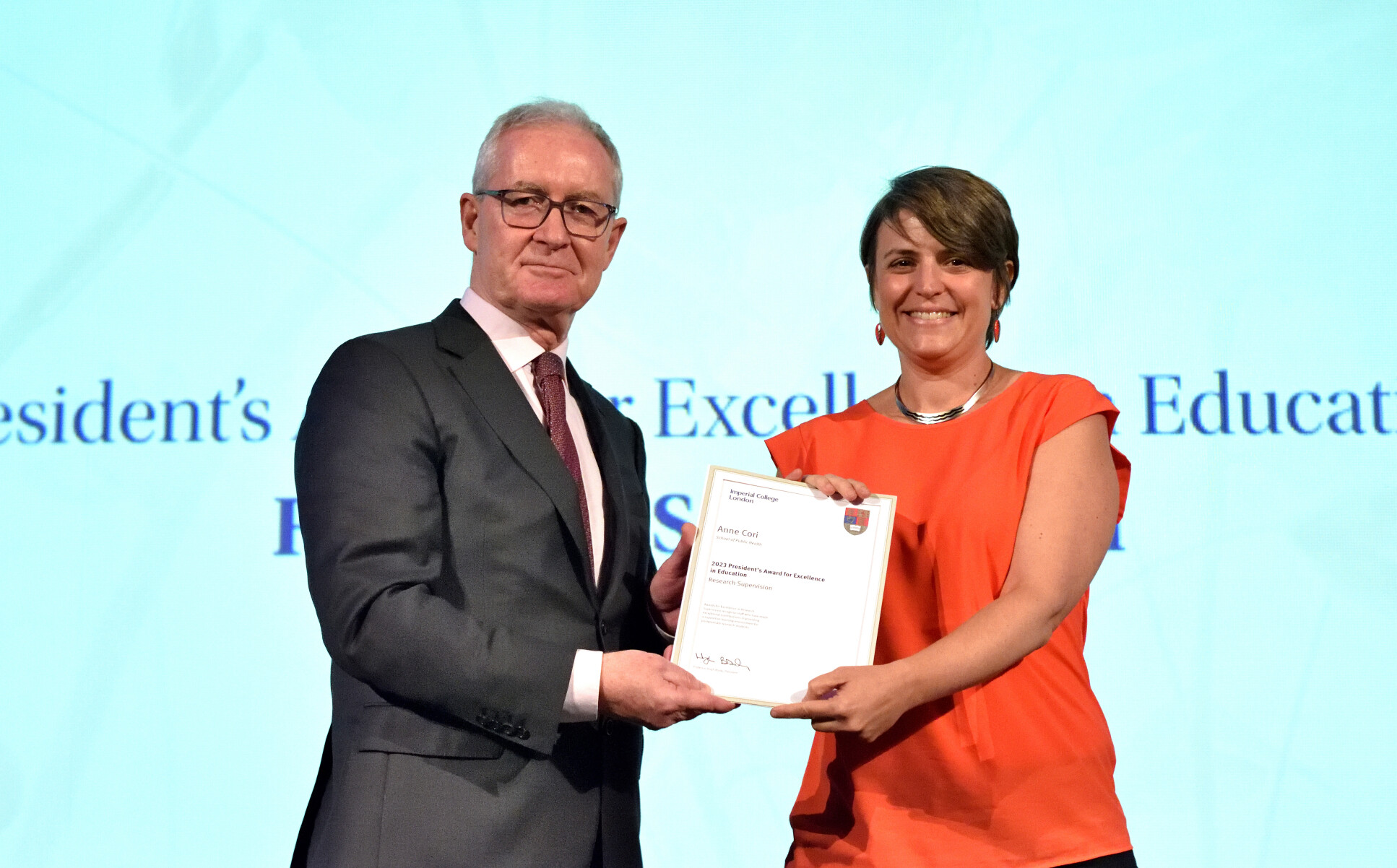 Dr Anne Cori receives an award from President Hugh Brady