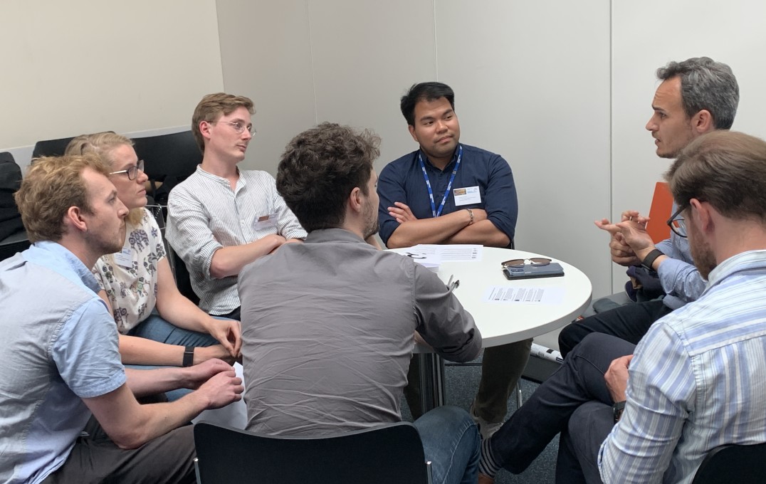 students talking with alumnus georgios zafeiropoulos