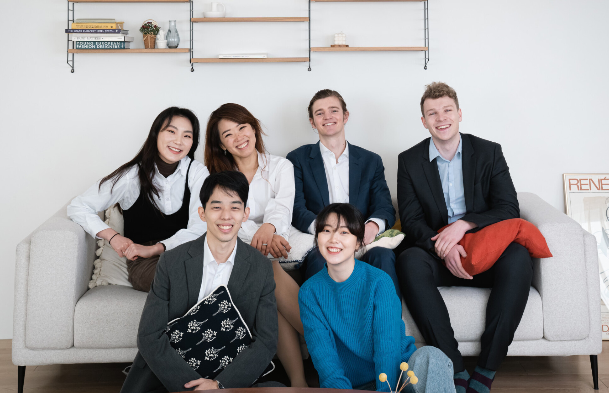 A group of people sit on a sofa