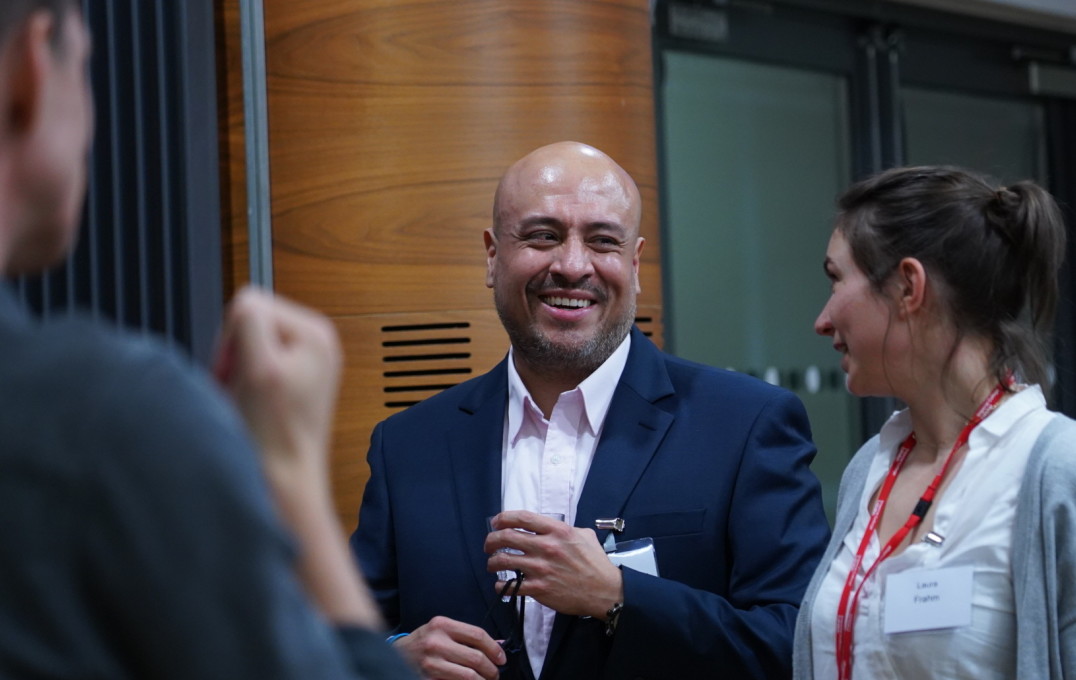 David Pedreros Bastidas talks with colleagues