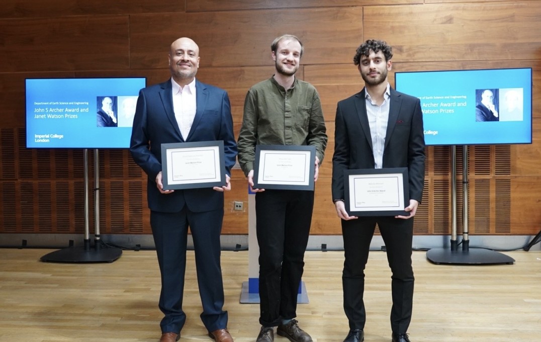 Winners stand together with certificates