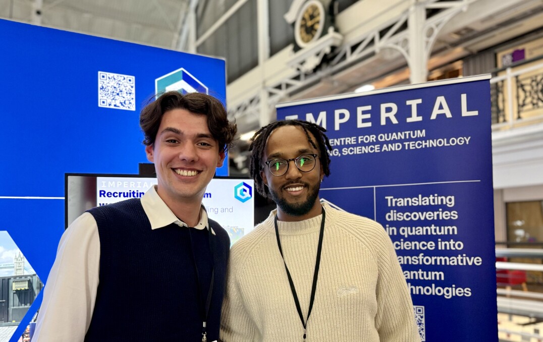 Particpants posing for a photo at the QuEST stand