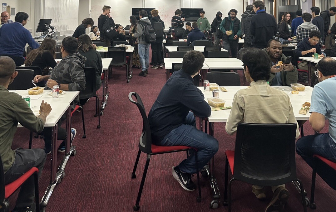 Students and staff sitting down to a meal