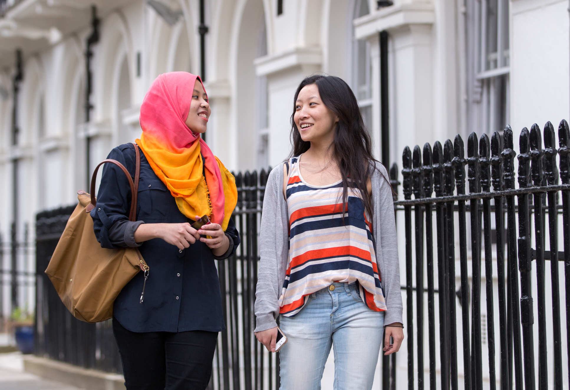 Two female students walking outside Wilson House