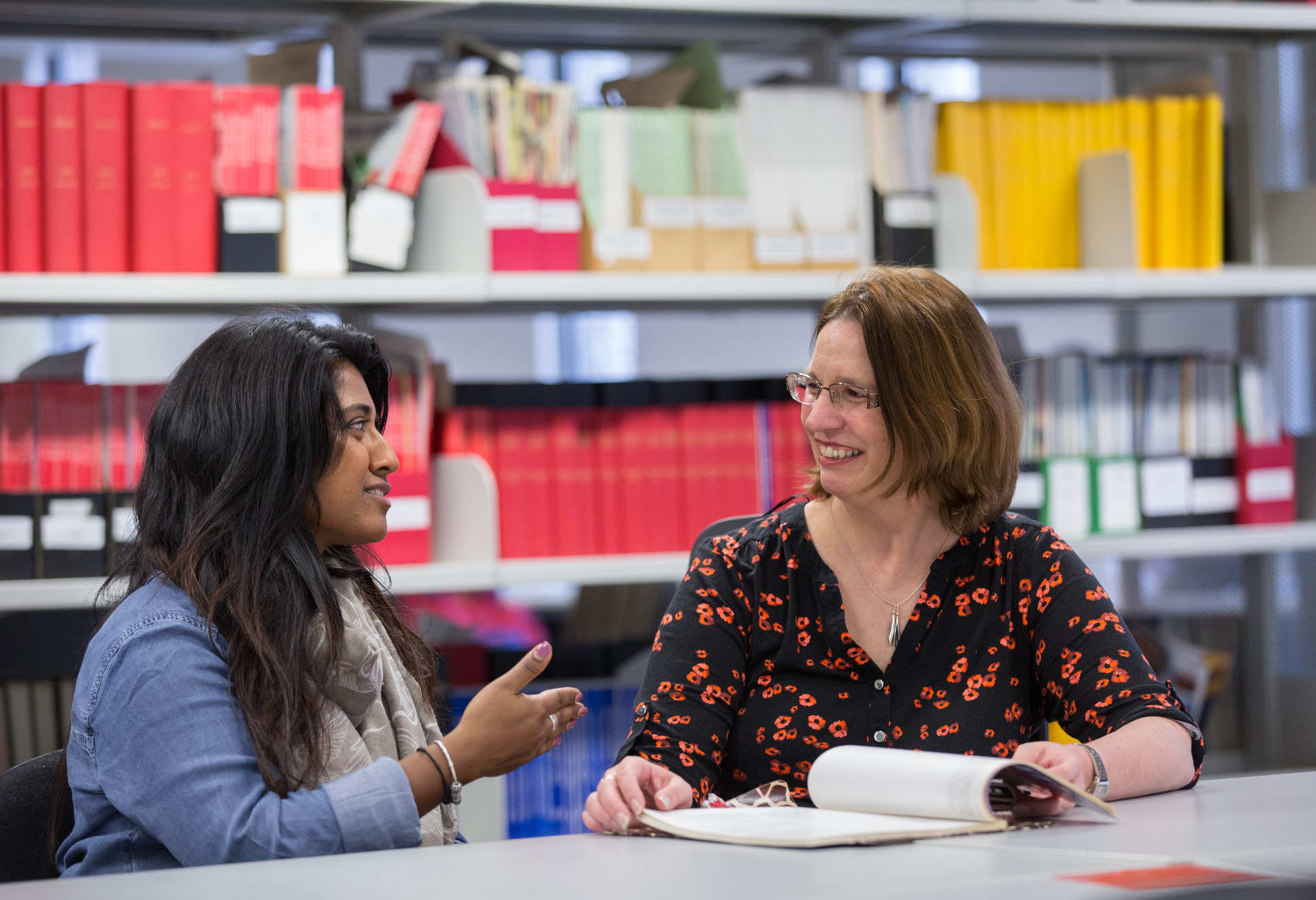 Two female colleagues converse