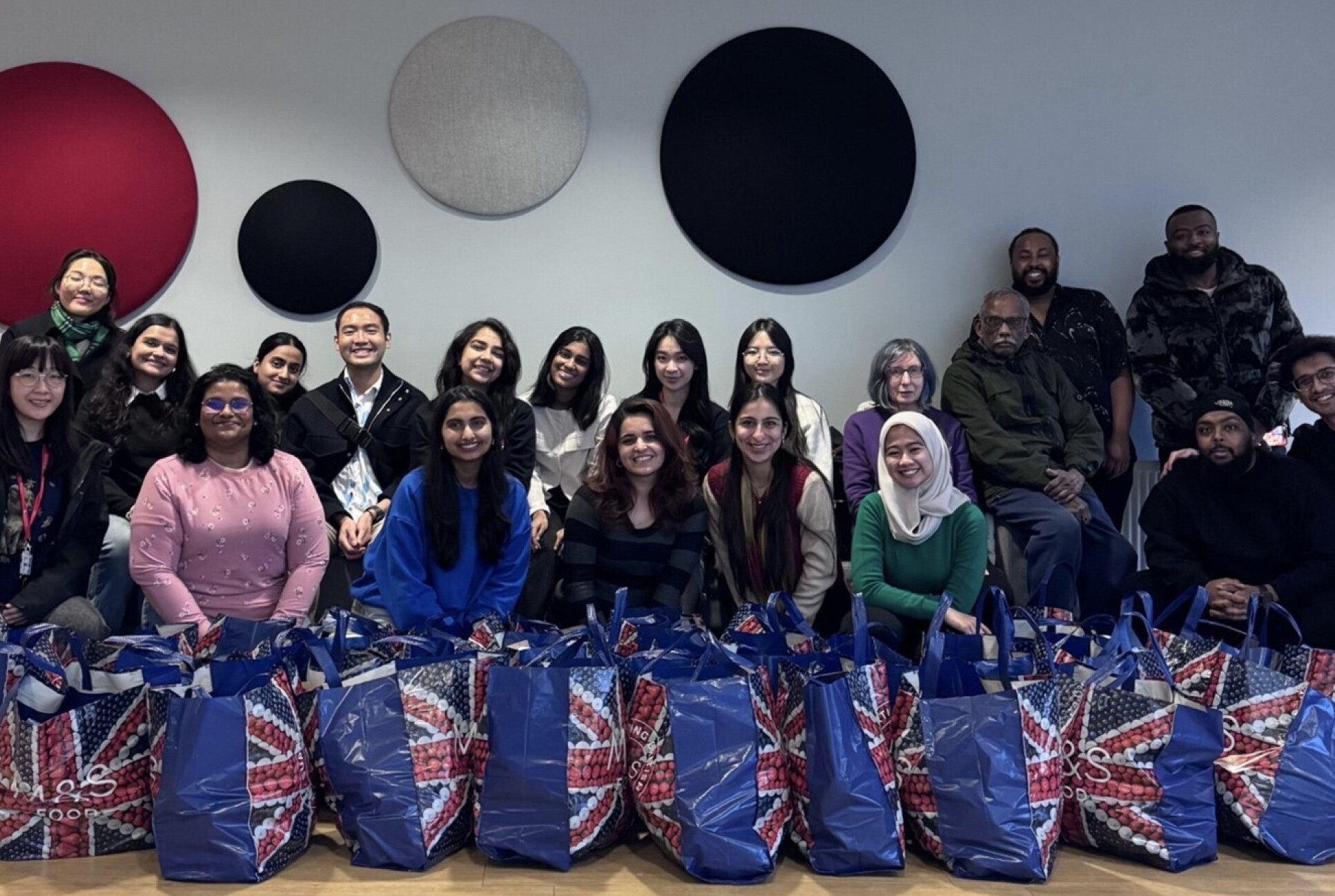 Smiling people posing with shopping bags