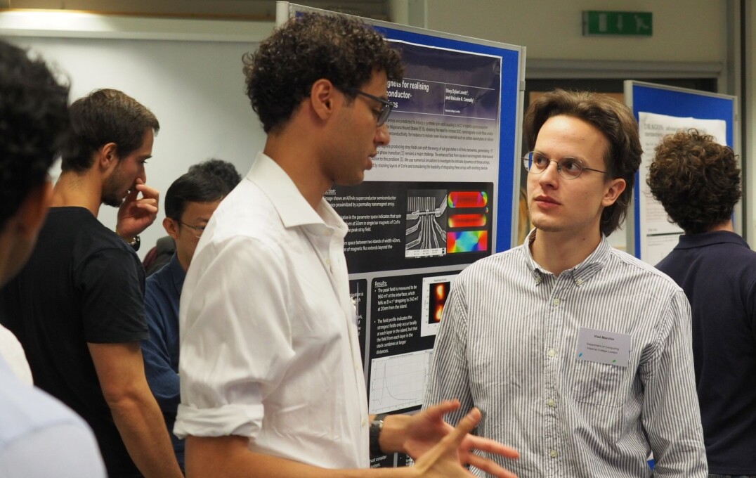 Attendees discuss ideas during the quantum poster session