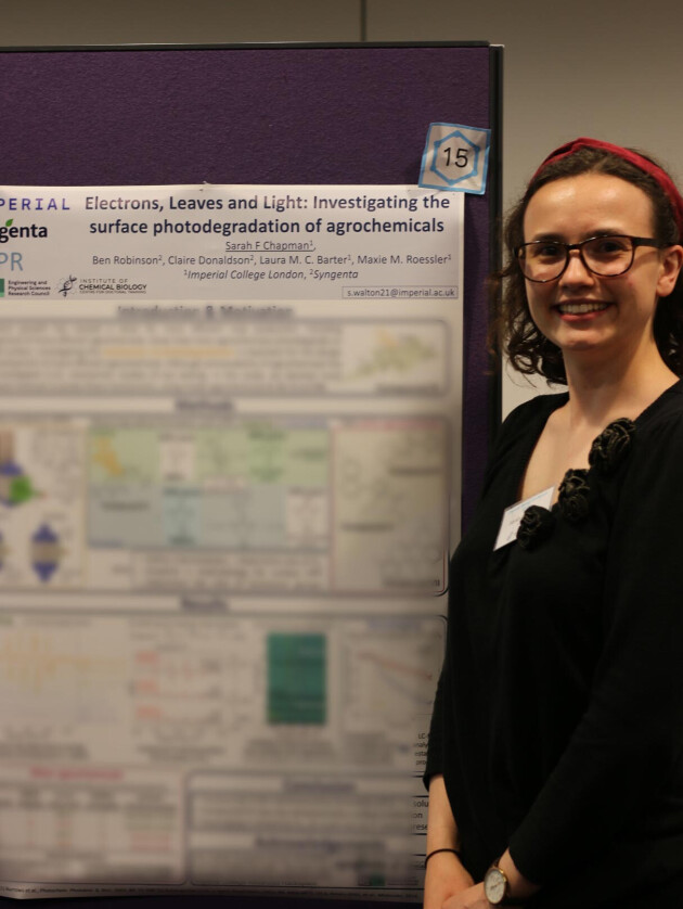 Woman standing next to poster board