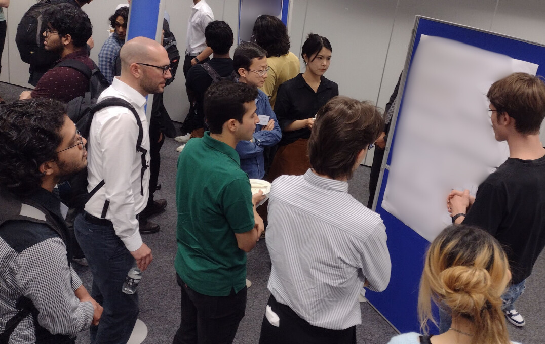 Attendees looking at a research poster during the conference