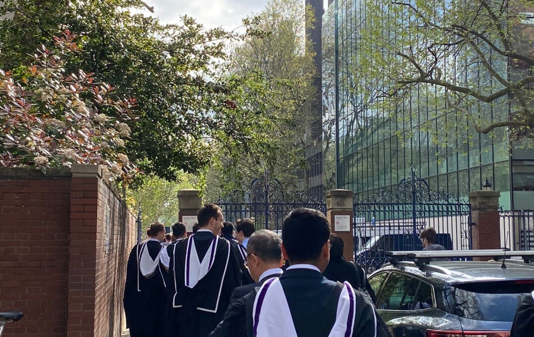 Graduands walking through campus in their gowns